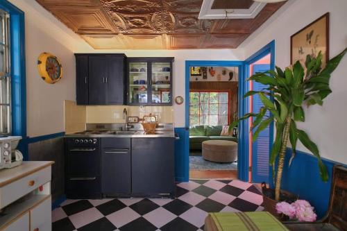 a kitchen with black cabinets and a potted plant at Vintage Lovers` Cabin with Jacuzzi & Lake Access in Linden