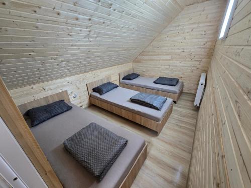 an overhead view of two beds in a wooden cabin at Cabana Soarelui - Valisoara in Vălişoara