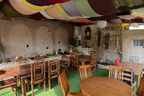 a dining room with wooden tables and chairs at Mensa Christi Guesthouse in Nazareth