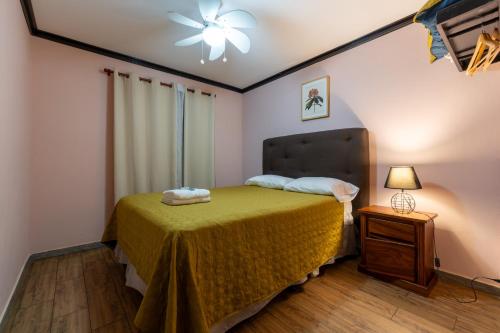 a bedroom with a bed and a ceiling fan at San Gabriel Apartments in Fortuna
