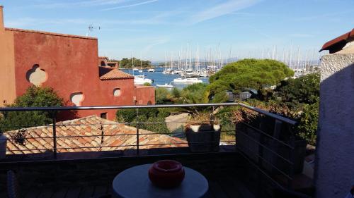 a balcony with a view of a harbor with boats at L'Arche de Porquerolles in Porquerolles