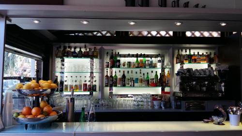 a bar with a lot of bottles of alcohol at L'Arche de Porquerolles in Porquerolles