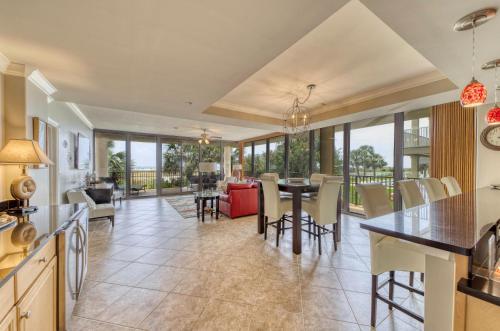 a kitchen and living room with a table and chairs at Holiday Isle 122 in Dauphin Island