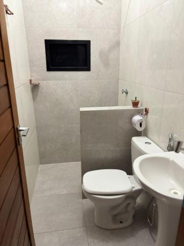 a bathroom with a toilet and a sink at Chalé da Ana in Tutóia