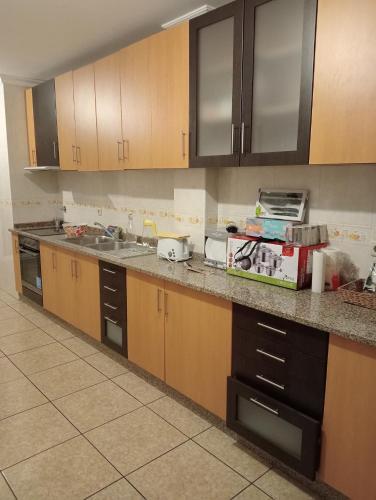a kitchen with wooden cabinets and a counter top at apartment with 5 bedrooms in Bragança