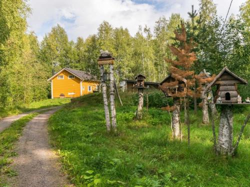 a house in the woods with a dirt road at Holiday Home Pöllö by Interhome in Verla