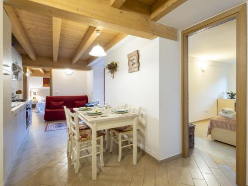 a kitchen and living room with a table and chairs at Apartment Casa del Bitto by Interhome in Pedesina
