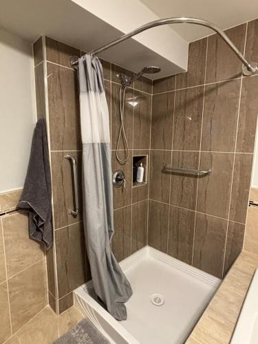 a shower with a shower curtain in a bathroom at Coastal Drift Sooke in Sooke