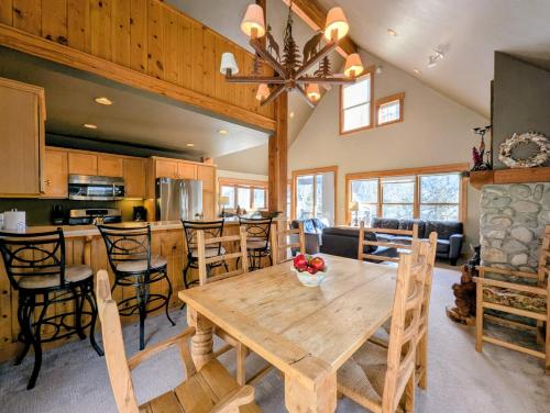 a dining room and kitchen with a wooden table and chairs at Cabin in the Pines 4 by SummitCove Lodging in Colorado in Keystone