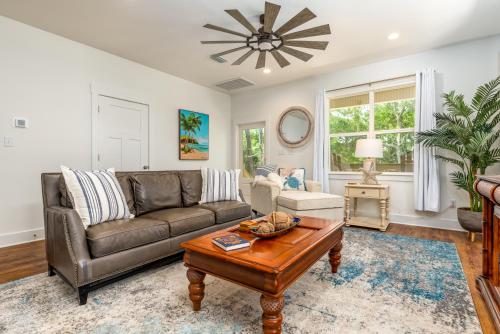 a living room with a couch and a table at Lavender Haze - 1209 Chaumont in Dauphin Island