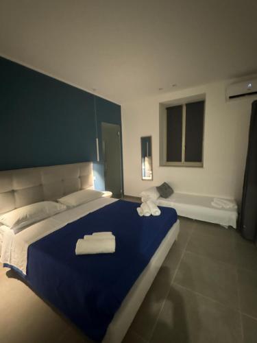 a hotel room with a bed with towels on it at Luxury Rooms Soraja in Palermo