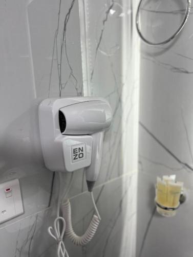 a phone hanging on a wall in a bathroom at WADl RUM DESERT CAMP in Wadi Rum