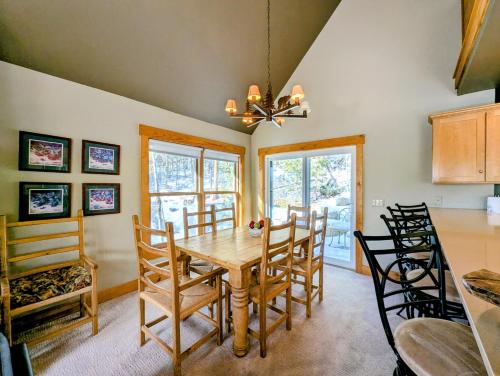 a dining room with a wooden table and chairs at Cabin in the Pines 4 by SummitCove Lodging in Colorado in Keystone