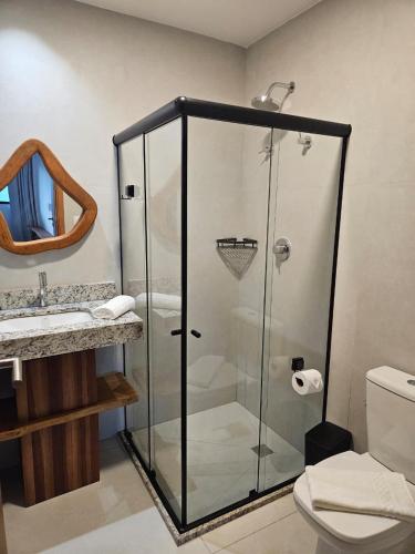 a bathroom with a shower with a toilet and a sink at Apartamento Ipioca Beach Life in Ipioca
