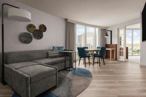 a living room with a couch and a table with chairs at Anaheim Marriott Suites in Anaheim