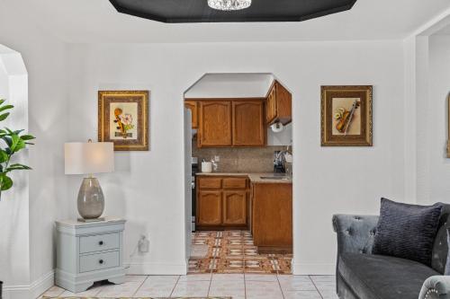a living room with a couch and a kitchen at Spacious 6 BR • Patio + Deck • Sleeps 13 in Sacramento