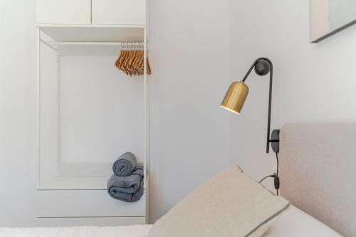 a white room with a white door and a lamp at RentitSpain - Playa Granada - Apartamentos TRM Aguacate Relax entre Mar, Golf y Montaña in Motril