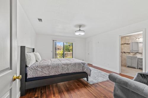 a bedroom with a bed and a living room at Spacious 6 BR • Patio + Deck • Sleeps 13 in Sacramento