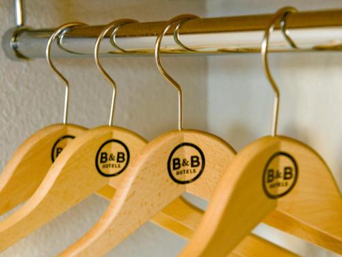 four wooden rackets with the words bkbarma on them at B&B HOTEL Moulins in Toulon-sur-Allier