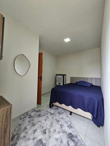 a bedroom with a blue bed and a rug at Maria Bonita Apartment | Cozy, 10 minutes from the city center in Caruaru