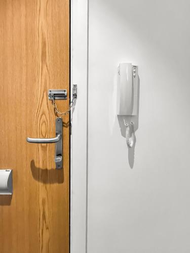a door with a pay phone attached to it at Flat 2 - Luxury Bolton City Centre Apartments in Bolton