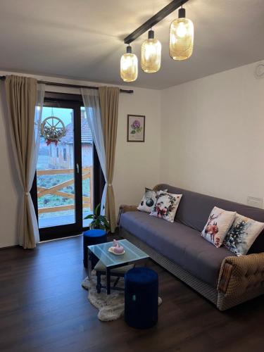 a living room with a couch and a table at Lavender farm Zarić in Porosanica