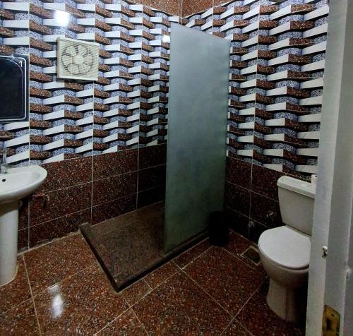 a bathroom with a toilet and a sink at El Agamy Hotel Apartment in Luxor