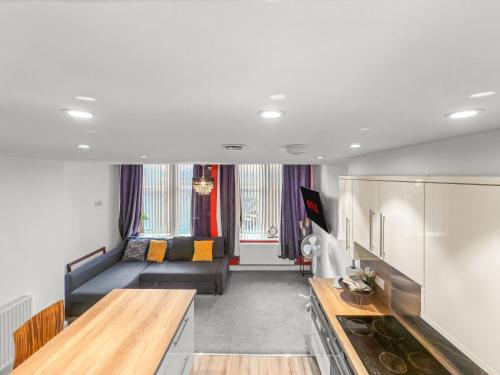a living room with a couch and a table at Flat 2 - Luxury Bolton City Centre Apartments in Bolton
