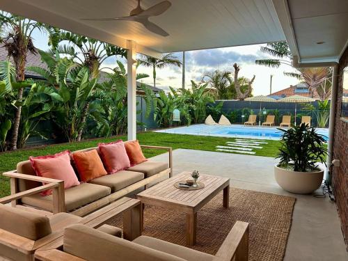 a living room with a couch and a table at Ballina Oasis in Ballina