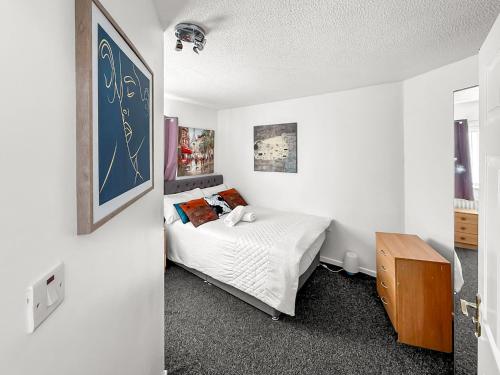 a bedroom with a bed in a white room at New Manchester Getaway Home - Free Gated Parking with Fob in Manchester