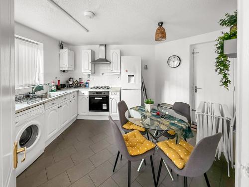 a kitchen with a table and chairs in a kitchen at New Manchester Getaway Home - Free Gated Parking with Fob in Manchester