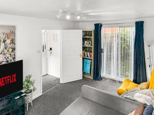 a living room with a couch and a book shelf at New Manchester Getaway Home - Free Gated Parking with Fob in Manchester