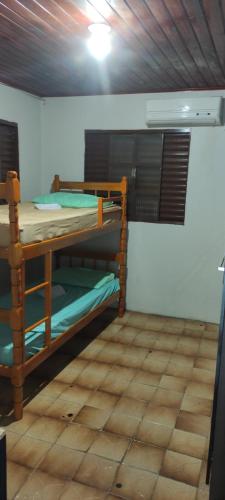 a room with two bunk beds in a room at Pousada Mosselini in São Gabriel