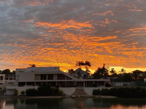 a building with a sunset in the background at Exclusive Sunrise Room, GC Blues Festival, Cool Autumn, Fire Pits, Fishing in Gold Coast