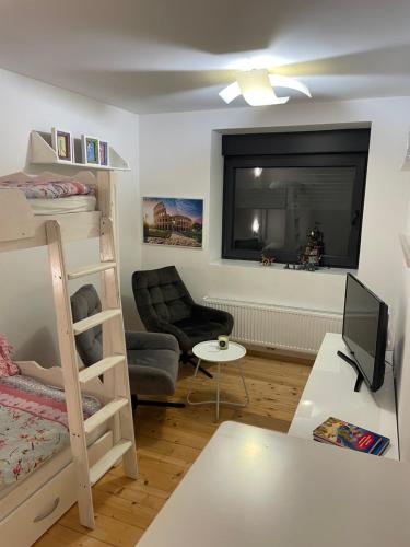 a living room with a bunk bed and a couch at WOOD hOUSE in Vrbovsko
