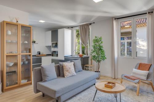 a living room with a couch and a table at Bright 2BR Apartments in Funchal Centre, Walk Everywhere in Funchal