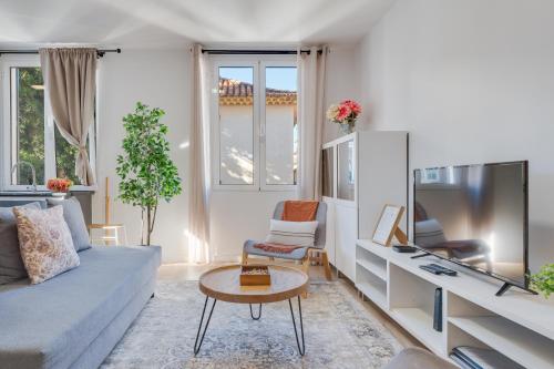 a living room with a couch and a tv at Bright 2BR Apartments in Funchal Centre, Walk Everywhere in Funchal
