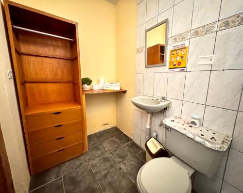 a bathroom with a toilet and a sink at La Casa de Isidora in Pan de Azúcar