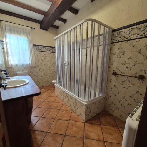 a bathroom with a shower and a sink and a tub at Finca Don Sancho by Mayne in Lillo