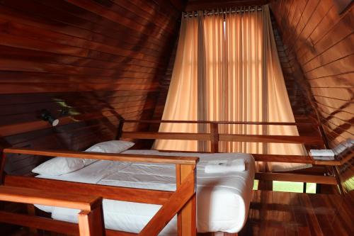 a bedroom with two bunk beds and a window at Alpinas Natural Suites in Lunahuaná