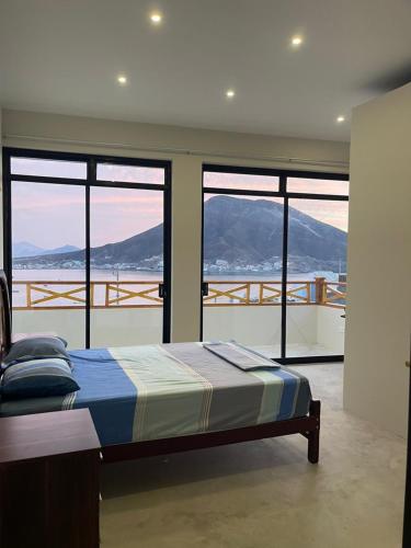 a bedroom with a bed with a view of mountains at Casa Apartment Playa Tortugas in Tortuga