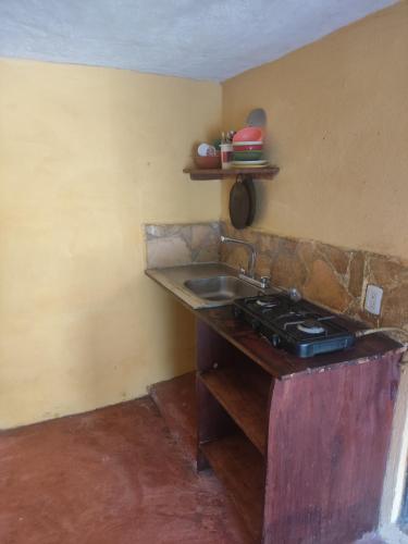 a kitchen with a sink and a stove at Cabañas la garita2 in San Cristóbal de Las Casas