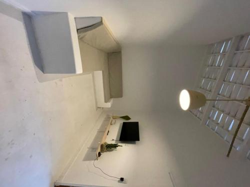 a room with a staircase and a white wall at Casa Carnaubas in Icapuí