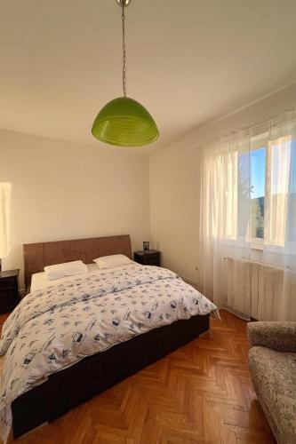 a bedroom with a bed and a green light at Apartments with parking space Korcula - 180 in Korčula
