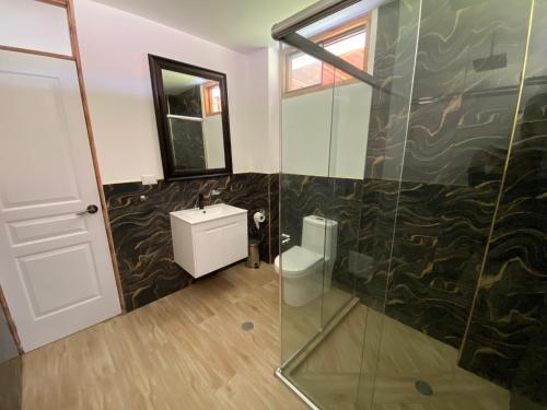 a bathroom with a shower and a sink and a mirror at La Casona - Hospedaje Campestre in El Carmen