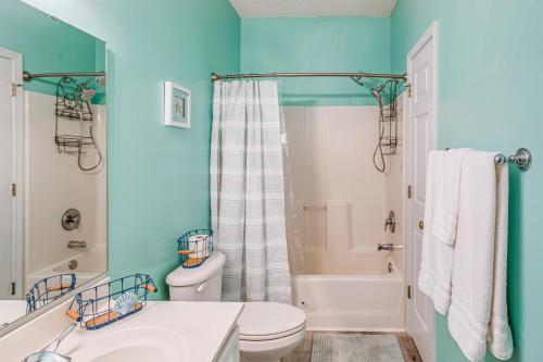 a bathroom with a white toilet and a tub at Condo w/ Pool Access, 1 Mi to Cherry Grove Beach in Myrtle Beach