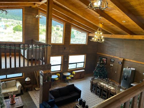 a living room with a christmas tree in a cabin at La Casona del atardecer in San Antonio de las Alzanas