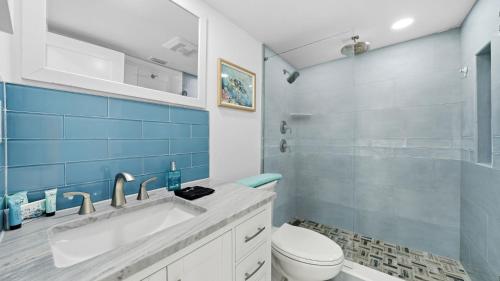 a bathroom with a sink and a toilet and a shower at Steps to the beach and amazing views! in Panama City Beach