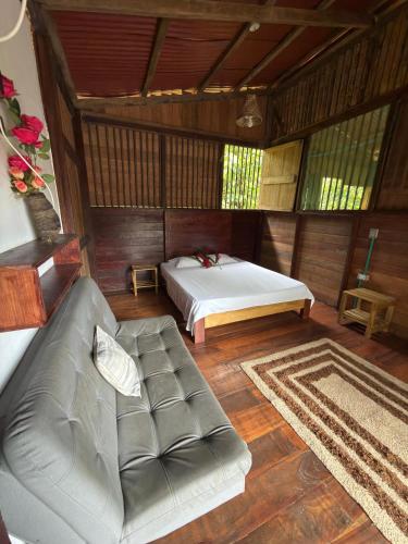 a living room with a bed and a couch at Casa Selva in El Valle