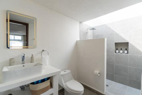 a white bathroom with a sink and a toilet at iKAL 93 Casa Nido de Mar 9 Persons Occupancy, Pool, 7 Beds in Nuevo Vallarta